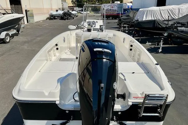 Slide: The Image of 2026 Bayliner Trophy T18 boat with outboard motor in a marina setting. - 19