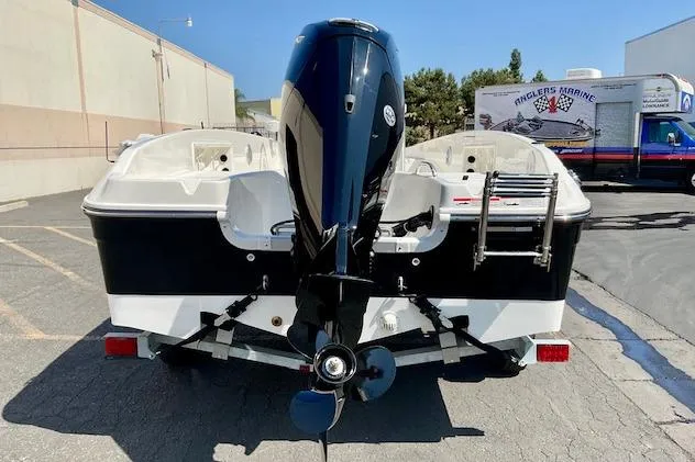 Slide: The Image of 2026 Bayliner Trophy T18 boat, rear view with outboard motor and ladder. - 4