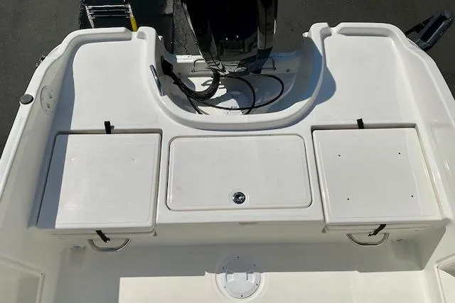 Slide: The Image of 2026 Bayliner Trophy T18 boat deck with storage compartments and motor mount. - 8