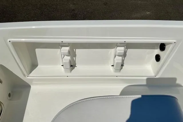 Slide: The Image of 2026 Bayliner Trophy T18 boat interior detail with white seating and storage compartment. - 9