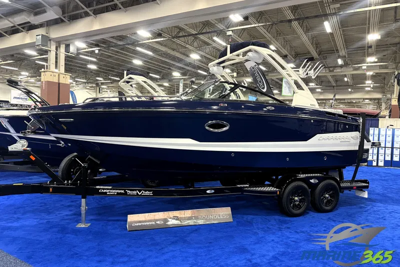 Slide: The Image of 2026 Chaparral GTS 6 boat displayed indoors on a trailer, blue and white design. - 0