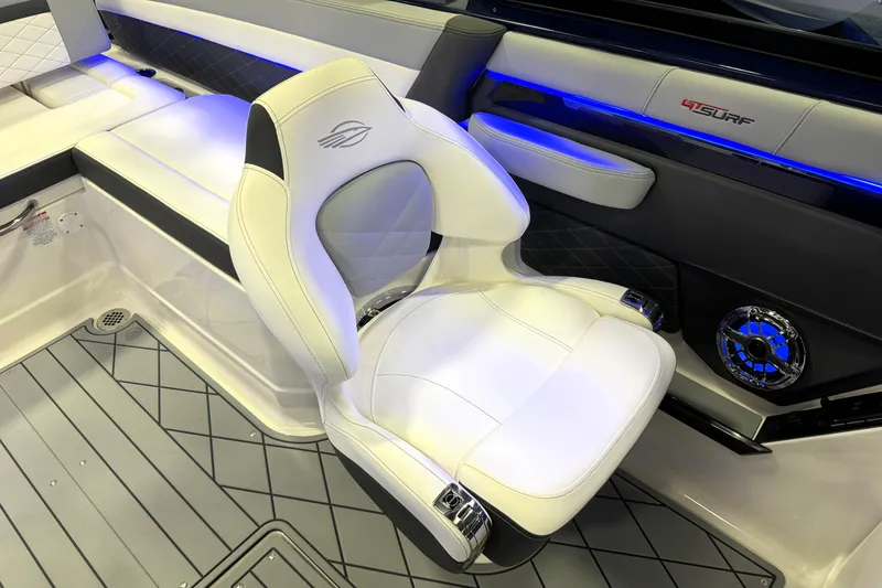 Slide: The Image of Luxury interior of 2026 Chaparral GTS 6 boat with white seating and blue LED lighting. - 14