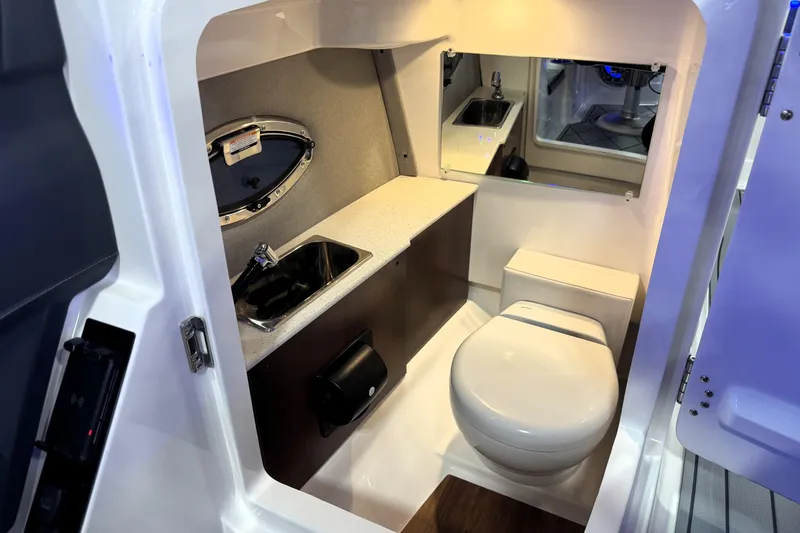 Slide: The Image of 2026 Chaparral GTS 6 boat interior bathroom with sink, toilet, and mirror. - 17