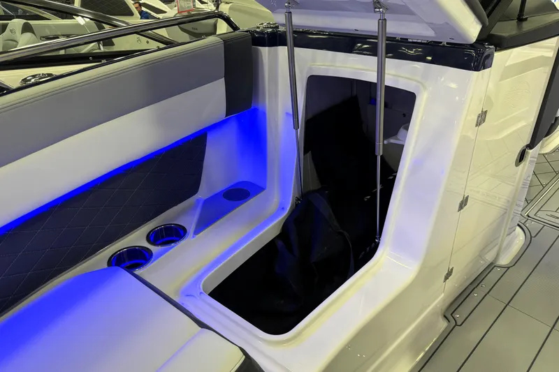 Slide: The Image of 2026 Chaparral GTS 6 boat interior with blue LED lighting and storage compartment. - 23