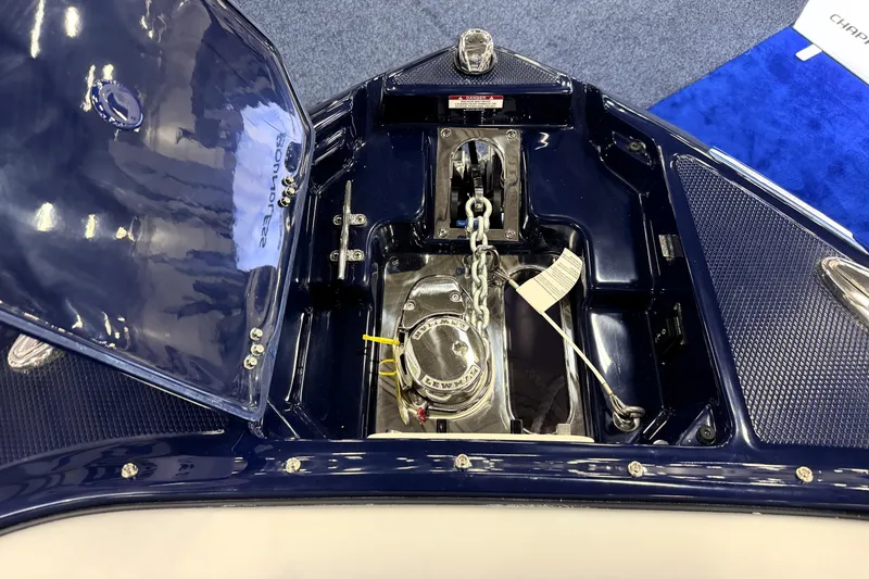 Slide: The Image of 2026 Chaparral GTS 6 boat anchor compartment with open hatch and chain mechanism. - 27
