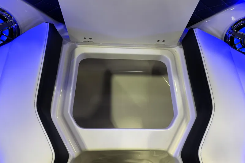 Slide: The Image of 2026 Chaparral GTS 6 boat storage compartment with sleek design and blue ambient lighting. - 28
