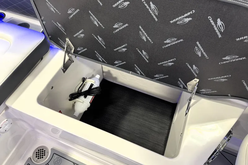 Slide: The Image of Open storage compartment in 2026 Chaparral GTS 6 boat with branded interior lining. - 35