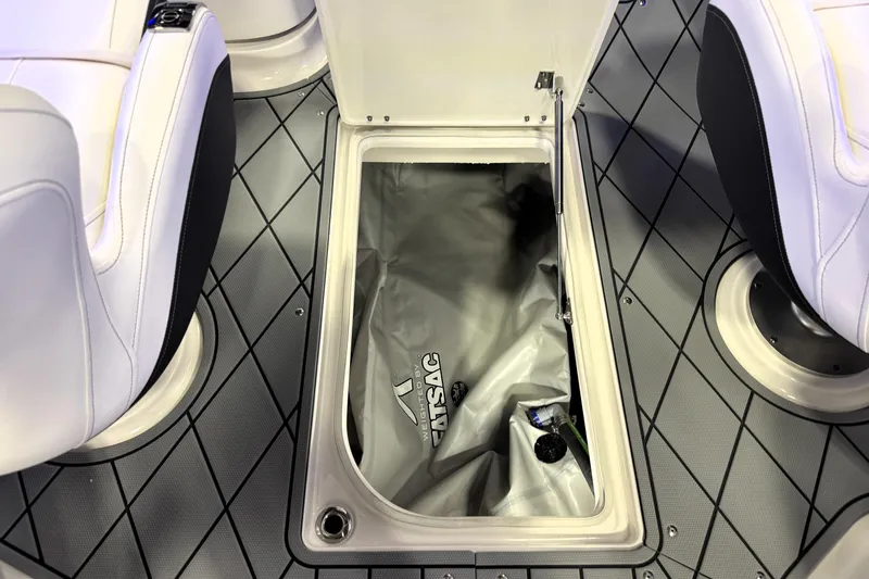 Slide: The Image of 2026 Chaparral GTS 6 boat interior storage compartment with gray flooring and white seats. - 37