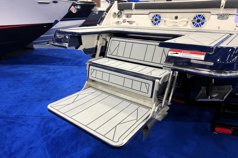 Slide: The Image of 2026 Chaparral GTS 6 boat with extended swim platform and blue carpeted floor. - 45
