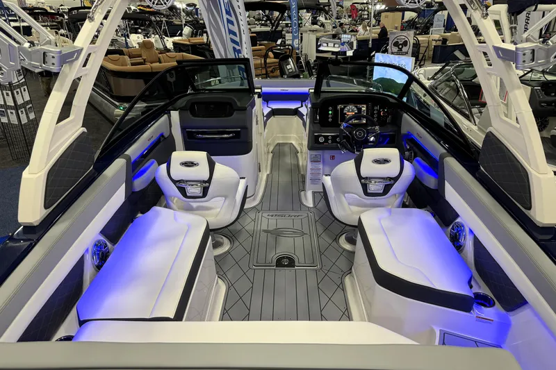 Slide: The Image of 2026 Chaparral GTS 6 boat interior with modern seating and illuminated dashboard at a showroom. - 49