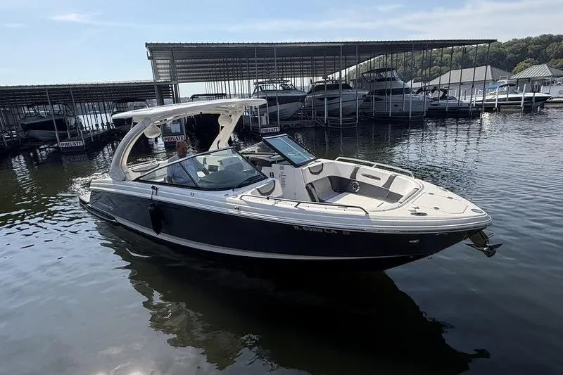The Image of 2021 Chaparral 307 SSX boat docked at a marina on a sunny day. - 0