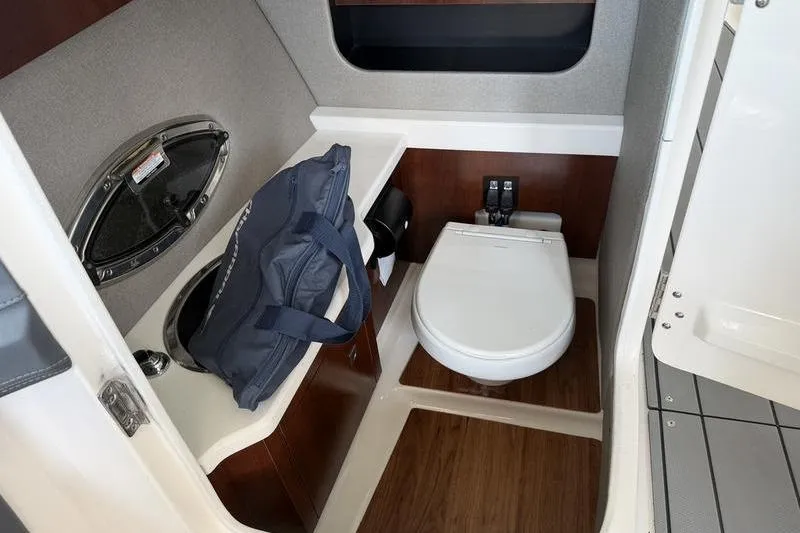Slide: The Image of 2021 Chaparral 307 SSX boat interior with toilet and sink area. - 11