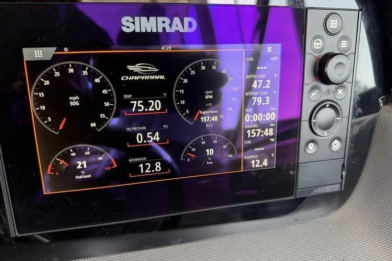 Slide: The Image of Simrad display on 2021 Chaparral 307 SSX showing speed, temperature, and engine metrics. - 12