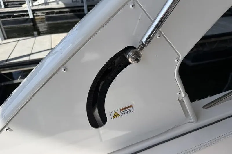 Slide: The Image of Close-up of 2021 Chaparral 307 SSX boat's adjustable mechanism with warning label. - 14