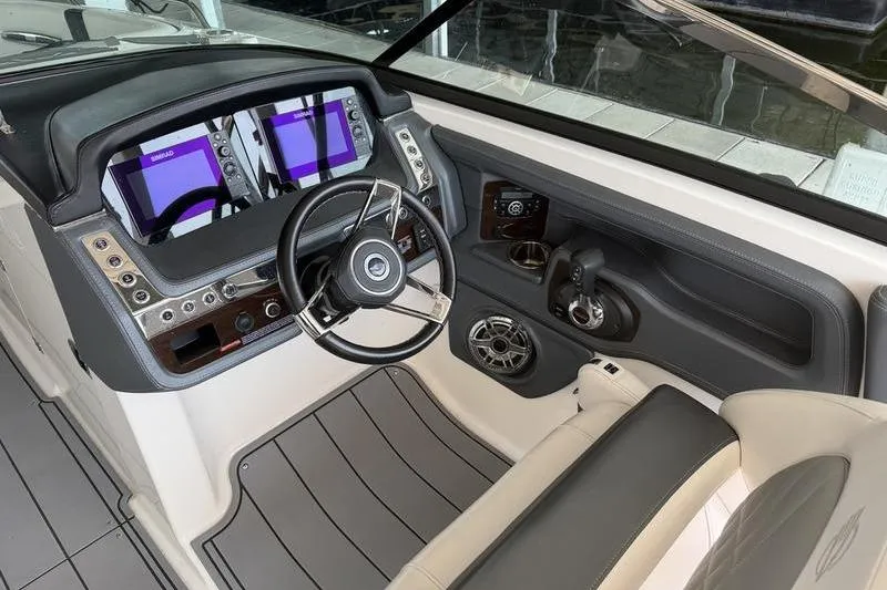 Slide: The Image of 2021 Chaparral 307 SSX boat cockpit with modern steering and dual displays. - 3
