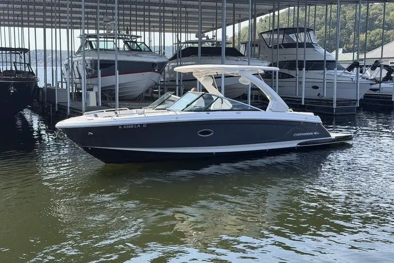 Slide: The Image of 2021 Chaparral 307 SSX boat docked in a marina under a covered area. - 4