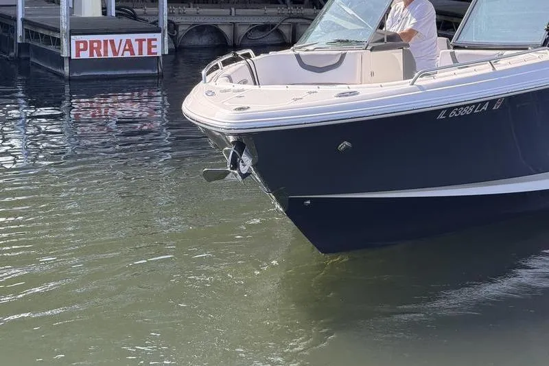 Slide: The Image of 2021 Chaparral 307 SSX boat near private dock, partially visible in water. - 5