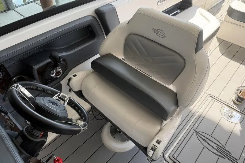 Slide: The Image of 2021 Chaparral 307 SSX helm with luxury seating and modern steering wheel design. - 9