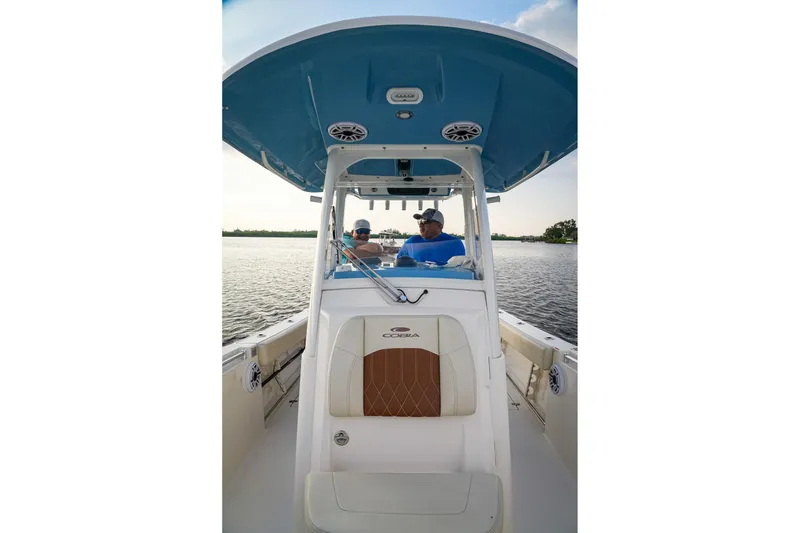 Slide: The Image of 2023 Cobia 262cc boat on water, featuring spacious seating and modern design. - 4