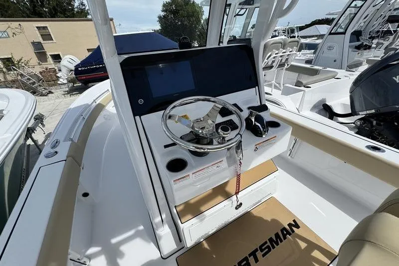 Slide: The Image of 2026 Sportsman Masters 247OE Bay Boat console with steering wheel and controls. - 10