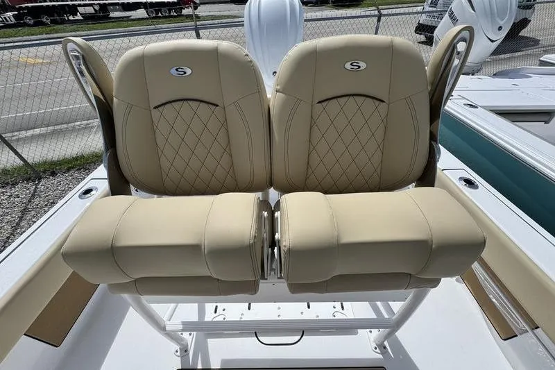 Slide: The Image of 2026 Sportsman Masters 247OE Bay Boat with tan cushioned seats and diamond stitching. - 11