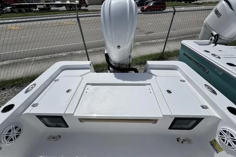 Slide: The Image of 2026 Sportsman Masters 247OE Bay Boat, rear view with engine and storage compartments. - 15