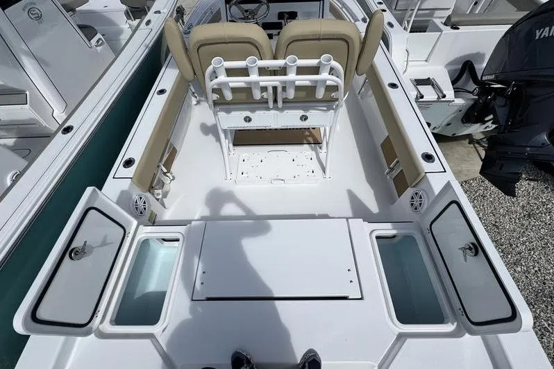 Slide: The Image of 2026 Sportsman Masters 247OE Bay Boat interior with seating and storage compartments. - 16