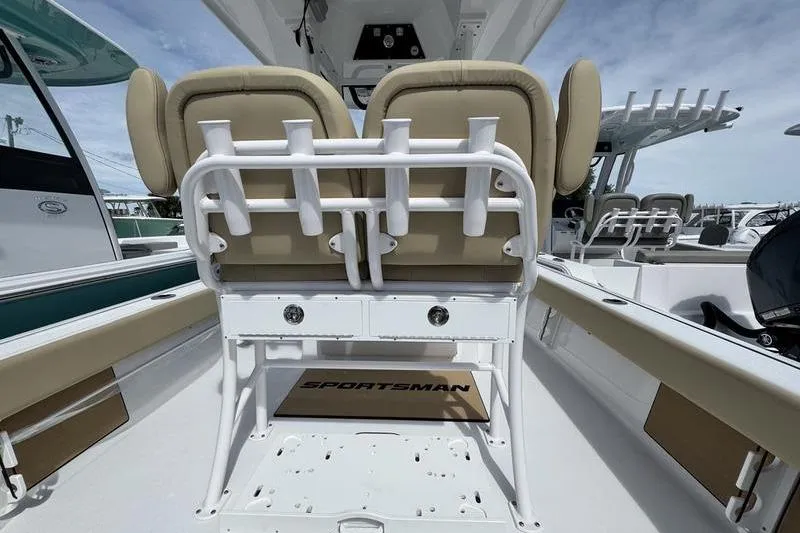 Slide: The Image of 2026 Sportsman Masters 247OE Bay Boat interior with dual seats and rod holders. - 19