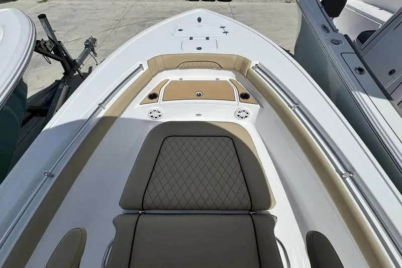 Slide: The Image of 2026 Sportsman Masters 247OE Bay Boat interior with tan seating and storage compartments. - 2