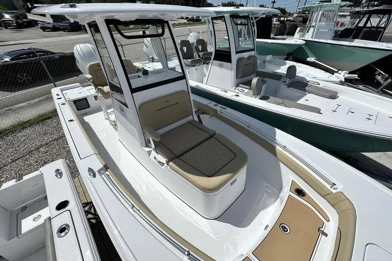 Slide: The Image of 2026 Sportsman Masters 247OE Bay Boat with tan seating, docked outdoors. - 20