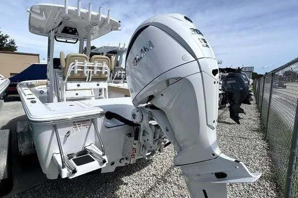 Slide: The Image of 2026 Sportsman Masters 247OE Bay Boat with Yamaha outboard engine, docked outdoors. - 24