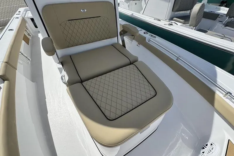 Slide: The Image of 2026 Sportsman Masters 247OE Bay Boat with tan cushioned seating and diamond stitching. - 3