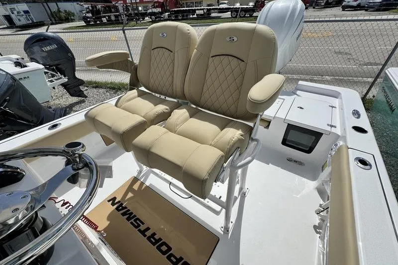 Slide: The Image of 2026 Sportsman Masters 247OE Bay Boat with beige cushioned seats and steering wheel. - 6