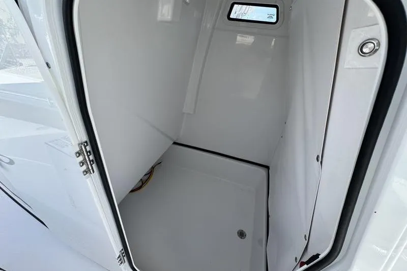 Slide: The Image of Interior cabin of 2026 Sportsman Masters 247OE Bay Boat, featuring sleek white design. - 8