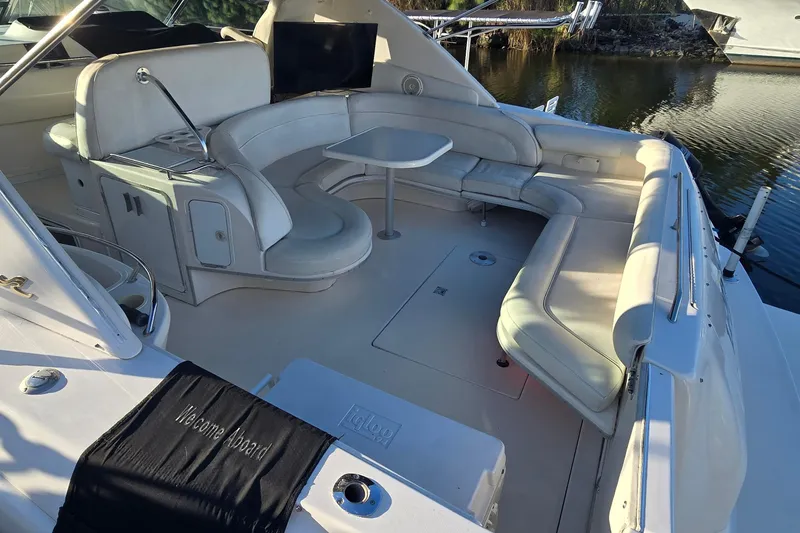 Slide: The Image of 1995 Sea Ray 450 Sundancer yacht with spacious seating and table on deck. - 7