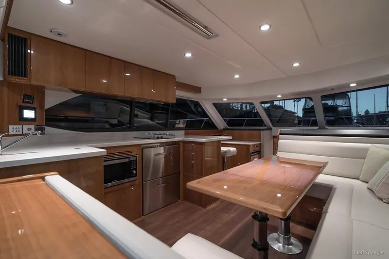 Slide: The Image of 2017 Riviera 43 Flybridge yacht interior with wooden stairs and seating area. - 12