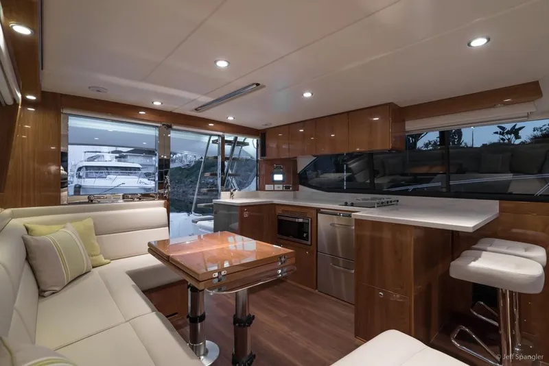 Slide: The Image of Luxurious 2017 Riviera 43 Flybridge interior with elegant seating and scenic water view. - 13