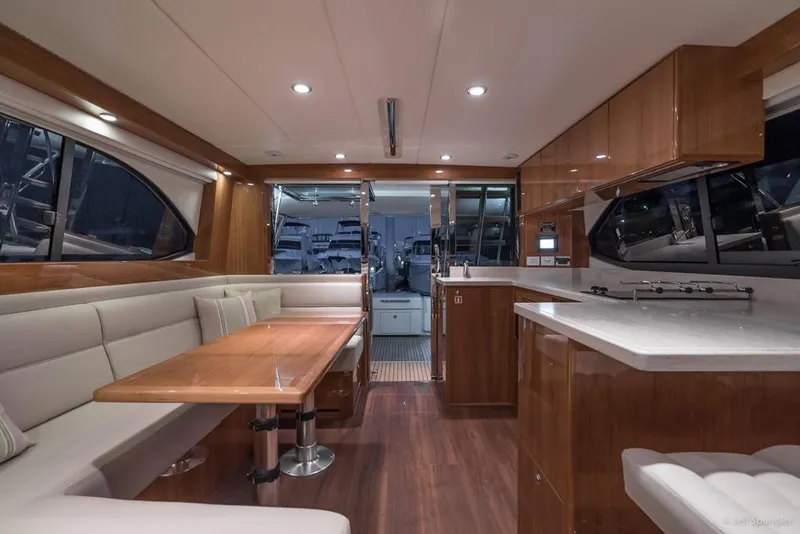 Slide: The Image of Luxurious seating area on 2017 Riviera 43 Flybridge yacht with city skyline view. - 14