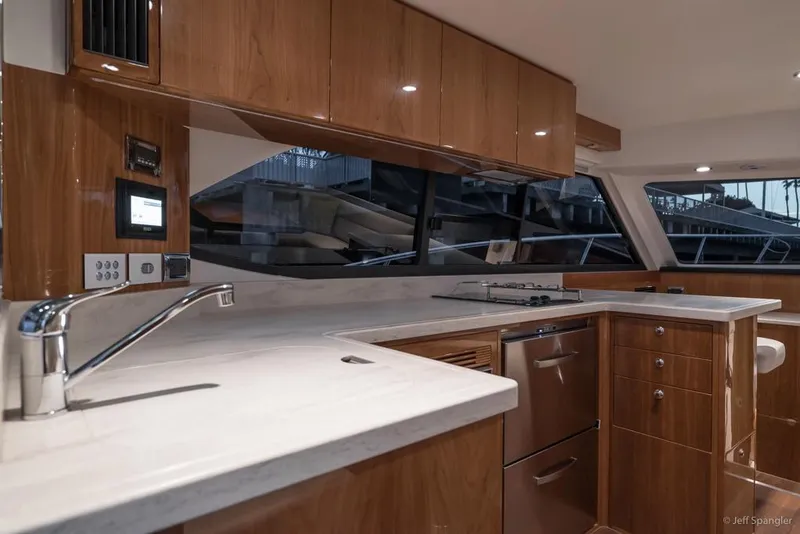 Slide: The Image of 2017 Riviera 43 Flybridge helm with modern controls and panoramic water views. - 15