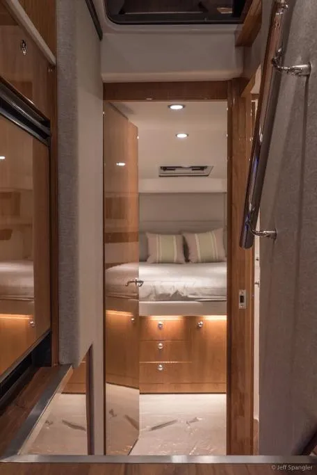 Slide: The Image of Riviera 43 Flybridge 2017 boat storage compartment with wooden steps and open hatch. - 20