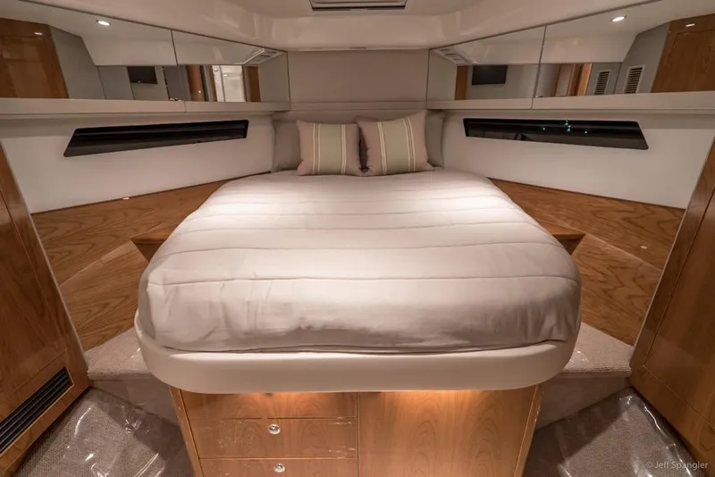 Slide: The Image of Open storage compartment on 2017 Riviera 43 Flybridge yacht with wooden deck. - 22
