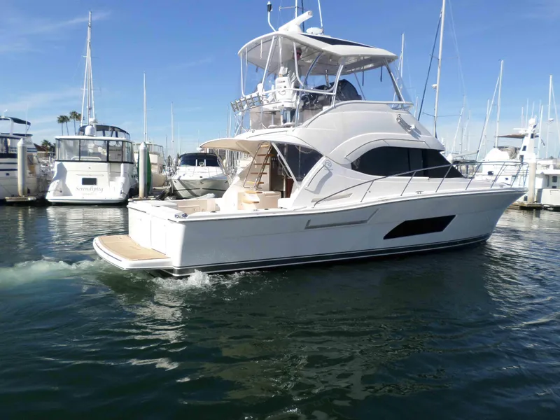 Slide: The Image of 2017 Riviera 43 Flybridge yacht on calm water at sunset. - 3