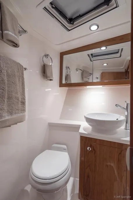 Slide: The Image of Luxurious interior of 2017 Riviera 43 Flybridge yacht with elegant seating and wooden table. - 32