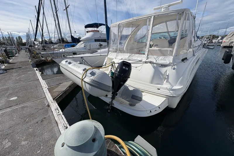 Slide: The Image of 2003 Sea Ray 360 Sundancer yacht docked at marina with inflatable boat attached. - 14