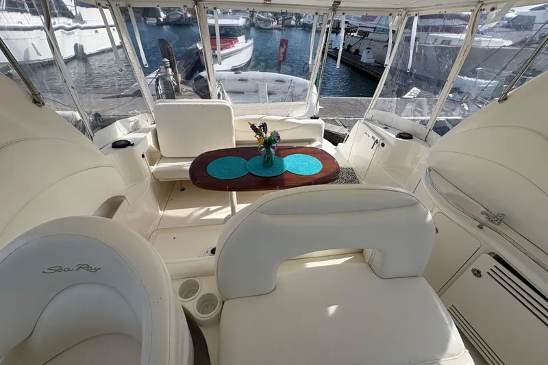 Slide: The Image of Interior of 2003 Sea Ray 360 Sundancer yacht with elegant seating and table setup. - 19