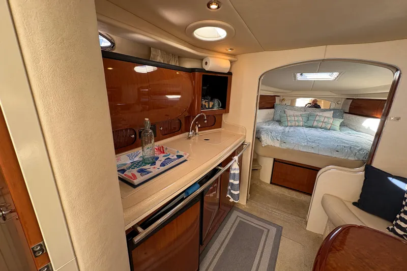 Slide: The Image of Interior of 2003 Sea Ray 360 Sundancer yacht with kitchenette and cozy bedroom. - 25