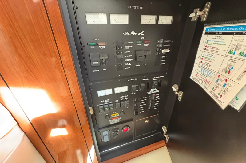 Slide: The Image of Electrical control panel of a 2003 Sea Ray 360 Sundancer boat, featuring switches and gauges. - 34