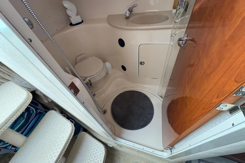 Slide: The Image of 2003 Sea Ray 360 Sundancer bathroom with toilet, sink, and shower area. - 38