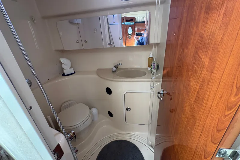 Slide: The Image of 2003 Sea Ray 360 Sundancer bathroom with toilet, sink, and mirrored cabinet. - 41