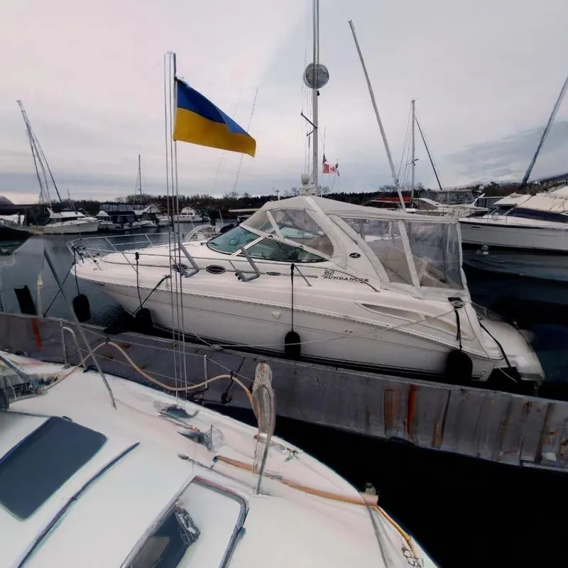 Slide: The Image of 2003 Sea Ray 360 Sundancer yacht docked, featuring a Ukrainian flag. - 6